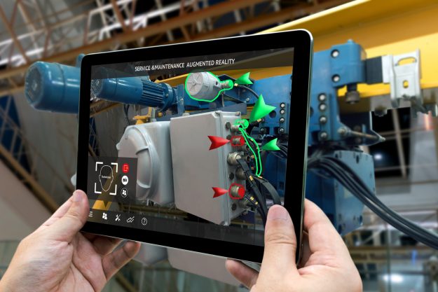 Industrial 4.0 , Augmented reality concept. Hand holding tablet with AR service , maintenance application and calling technician for check destroy part of smart machine in smart factory background